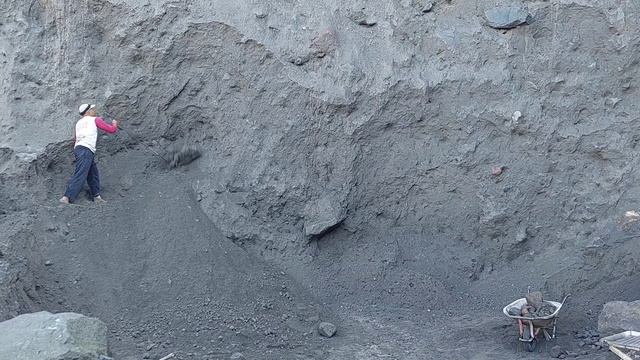 Строительство, шахтёры сбивают крупные камни со стен карьера