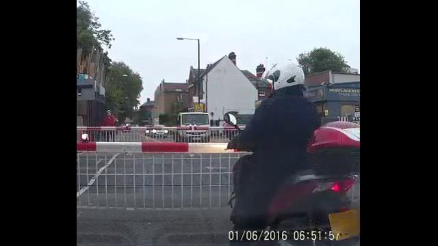 Father sprints under closing level crossing barriers with baby
