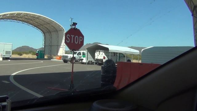 Thumbs Up at U.S. Border Patrol Checkpoint Stop - Agent signals Driver with a half hearted Thumb