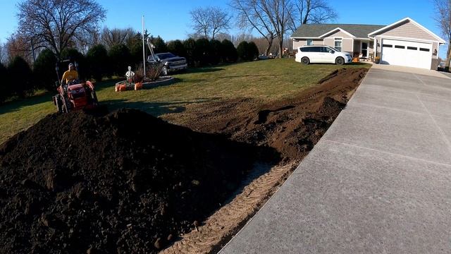 65 tons of black dirt graded around our new driveway - compact tractor