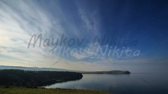 Russia, Lake Baikal, Olkhon Island, Clouds and stars on a moonlit night over Small Sea Bay. Cape Sa