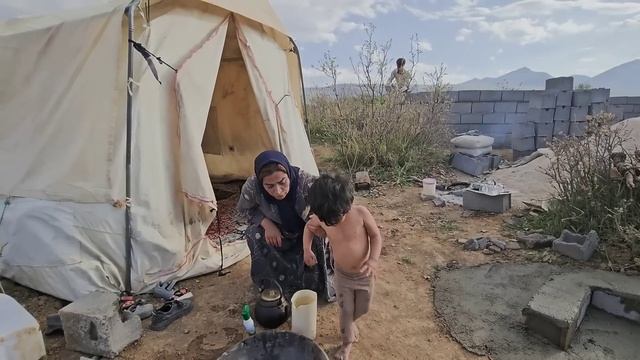 Emmbers of Resilience: Ali Family's in Constructing a Fire Fireplace and Finishing Shelter Walls
