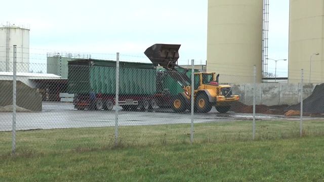 Volvo L120F loading wood chips for the truck and wood chip pile in 2013