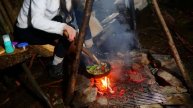Bushcraft camping in the rain, primitive building shelter and bed, outdoor cooking