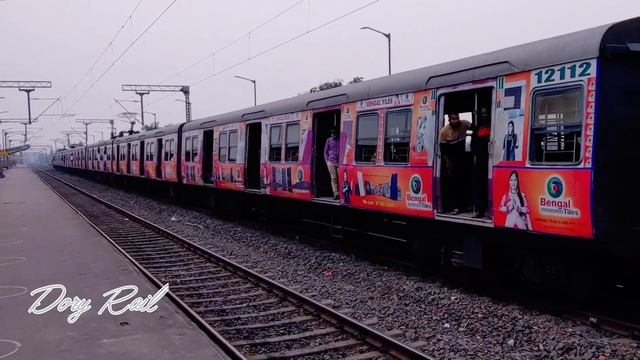 Brilliant color EMU local train Running over the tree level