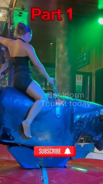 Bull 🐂 riding in black dress 👗 #dance #rodeo #foryou #benidormbeach #bullriding #beach #funny