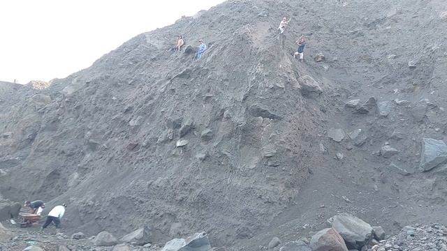 Строительство, шахтёры сбрасывают песок и камни со стен карьера