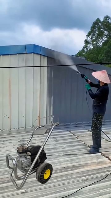 The process of painting a building roof using a compressor machine #shorts