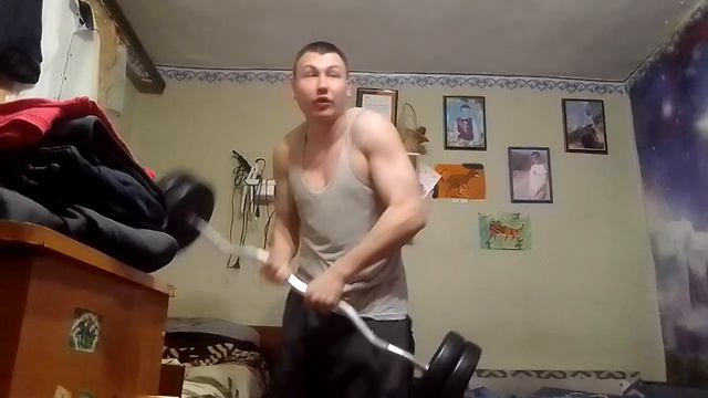 поднял штангу одной рукой вверх.