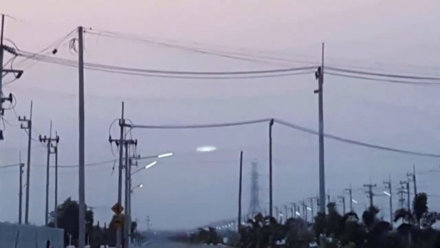 Огромный плоский диск был заснят человеком ранним утром где-то над городом в 2019 году
