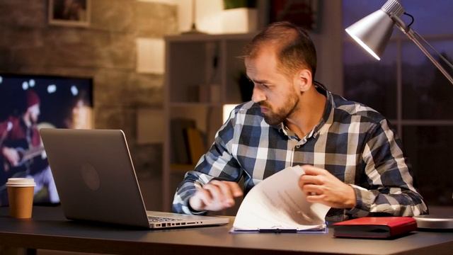 mixkit-man-doing-research-on-laptop-from-home-office-5518-hd-ready