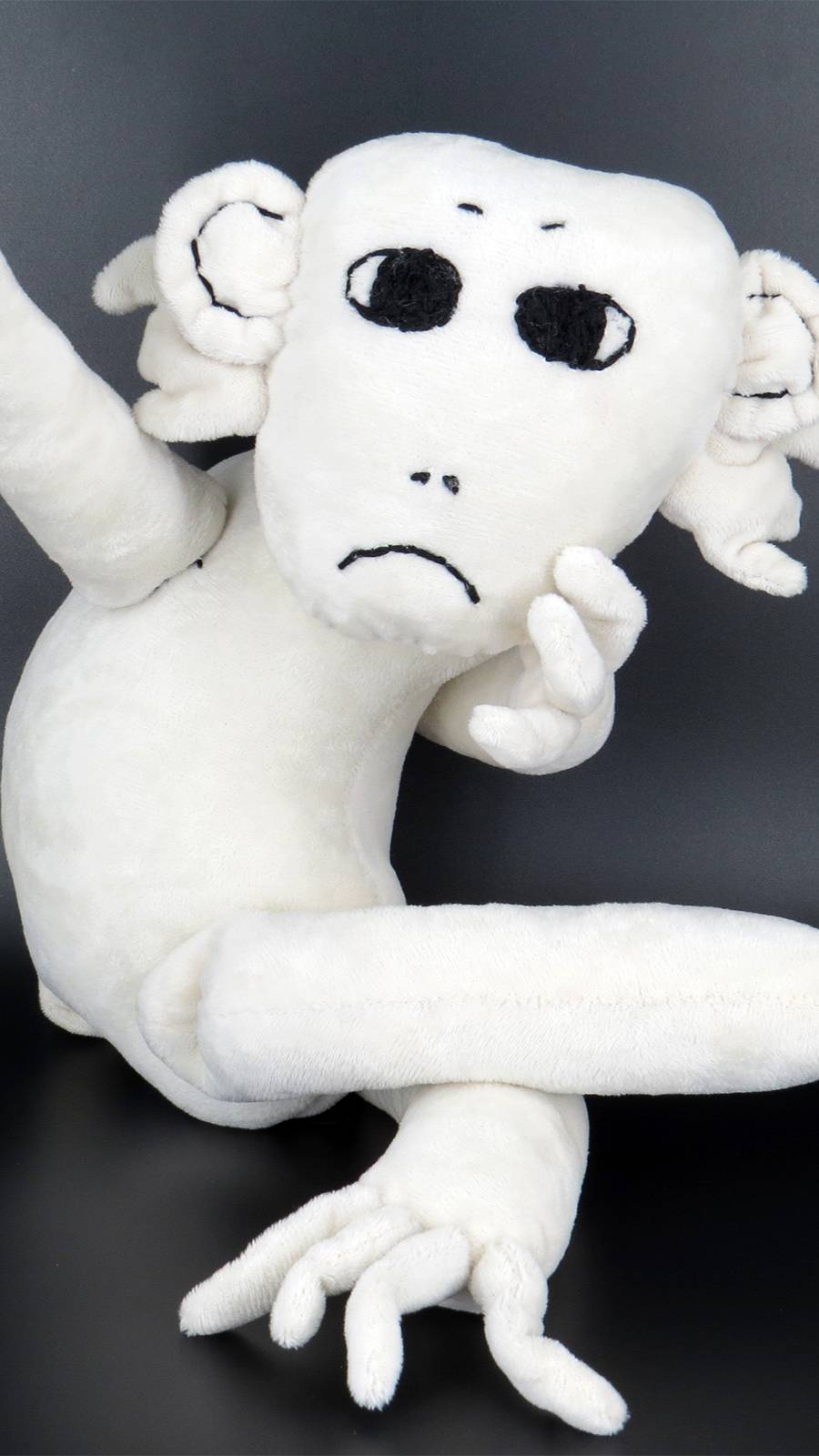 White gloomy monkey with yellow banana is sitting