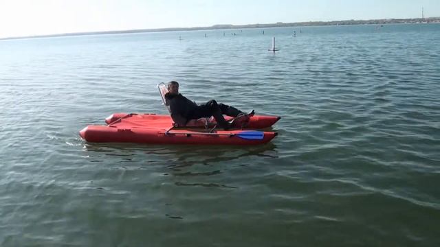 Pedal-power boat water bike catamaran with luggage carrier cargo. River travel and rafting. Test.