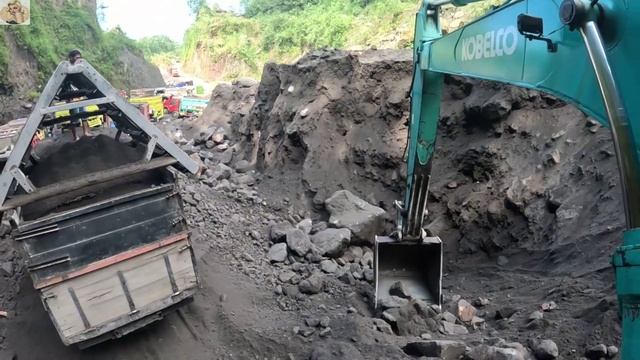Строительство, экскаватор копает чёрный песок