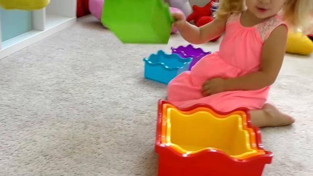 Диана и Рома Диана играет с цветной игрушечной пирамидкой