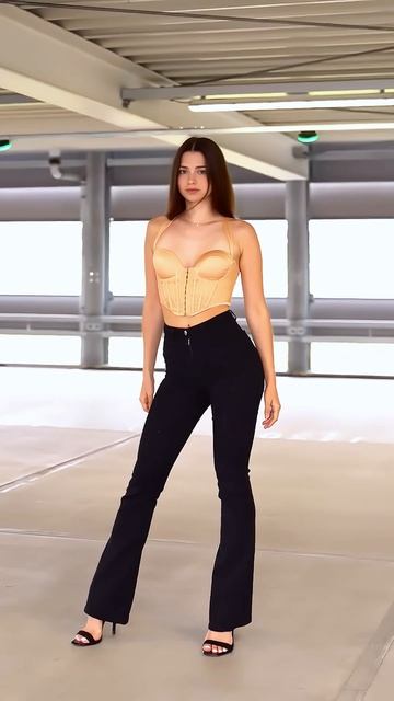 nuq9xBUFkz0 - Beautiful model is tight black bell bottom pants street style outfit #fashion #style #