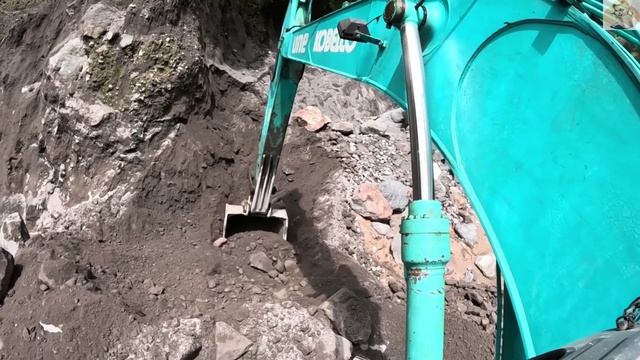 Строительство, экскаватор копает чёрный песок