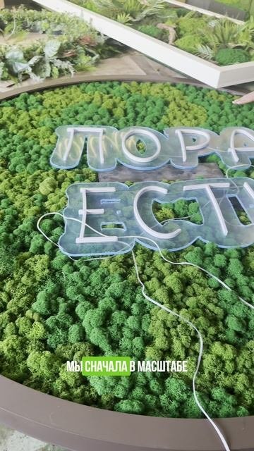 Панно-логотип из мха разных оттенков