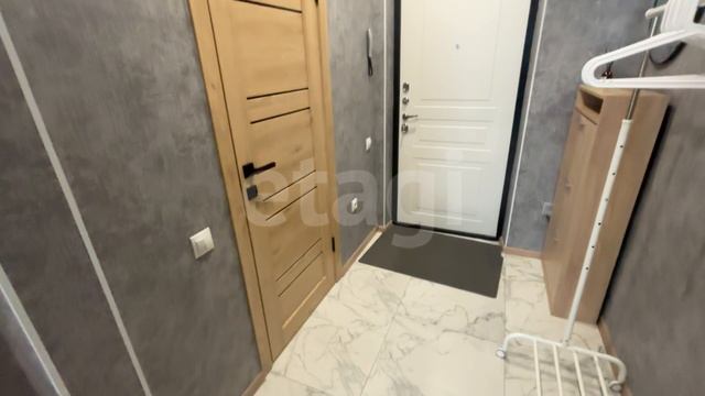 9976877