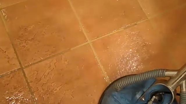 Shamrock cleaning tile and grout so the floor looks new.