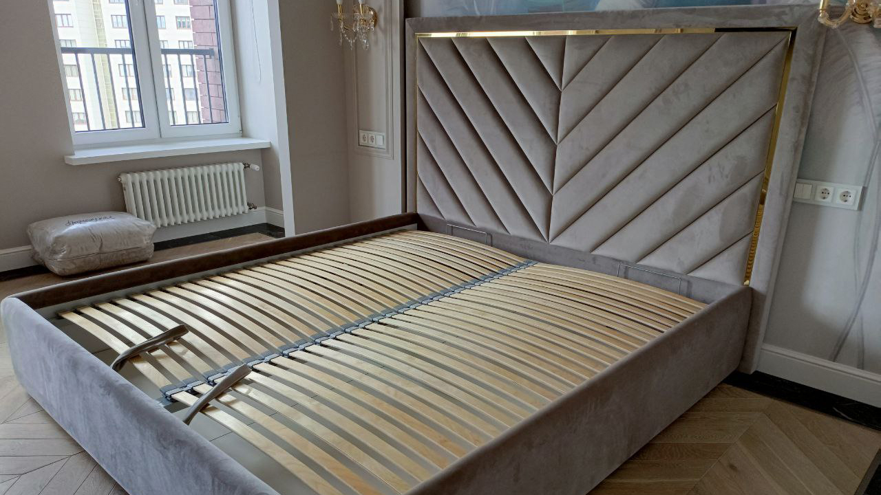 Кровать дизайнерская в интерьере с золотым молдингом