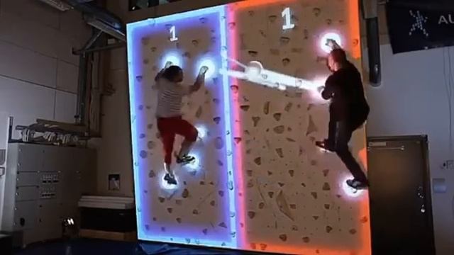 Climball is an augmented rock-climbing-wall plus air hockey game