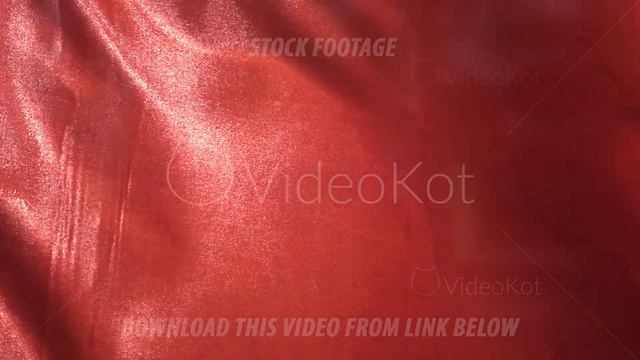 A red waving flag in close-up and slow motion