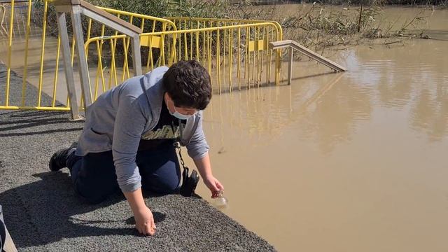For Christians -12-year-old boy fills bottles of holy water from the place where Jesus was baptized