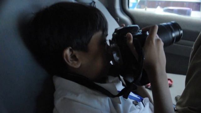 My brother tinkering with a Nikon D80 + telephoto lens