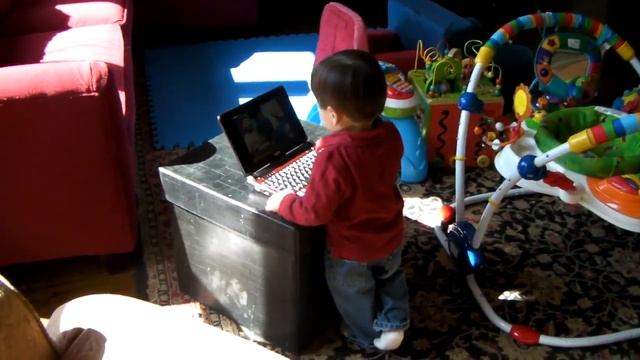 Dean gets distracted from watching tv on his netbook