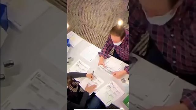 US election fraud - demorats inside polling area filling out BLANK BALLOTS