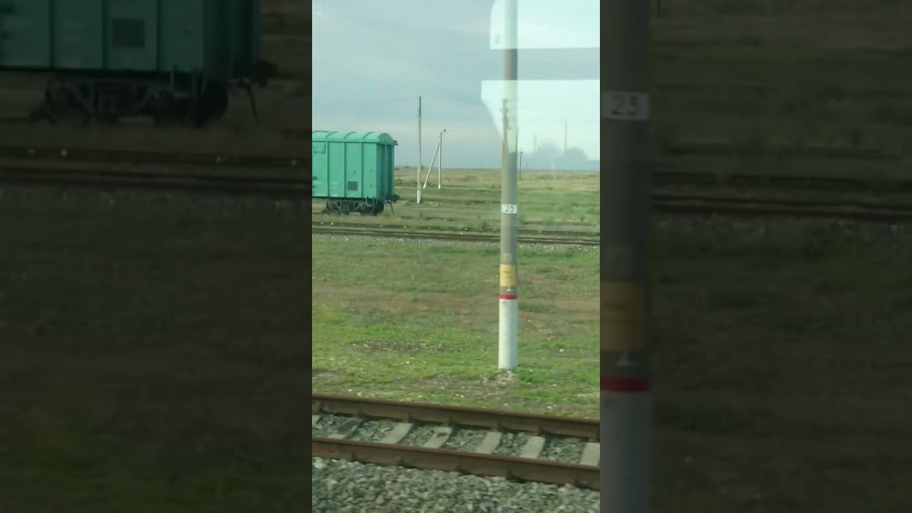 Одинокий товарный вагон на железнодорожном пути в степи Lonely freight car railway track in steppe