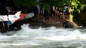 Surfing on the Hofgarten public park river in Munich