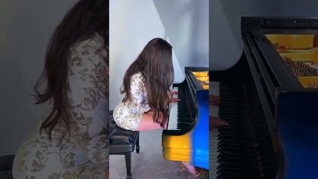 Lola Astanova. Plays a talented virtuoso on the piano.