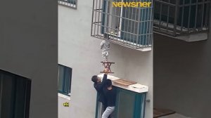 Heroes climbs out the window to save a toddler dangling from 4th-floor