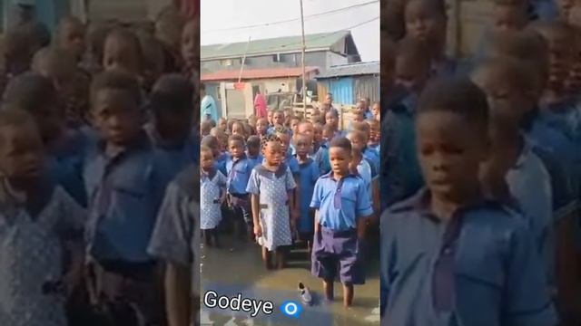 This country has suffered! See young pupils 🚸 reciting national anthem on a flooded ground. Too bad