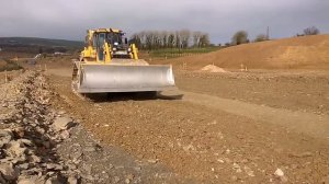 CAT D6 dozer at work levelling stone on a road construction site #2