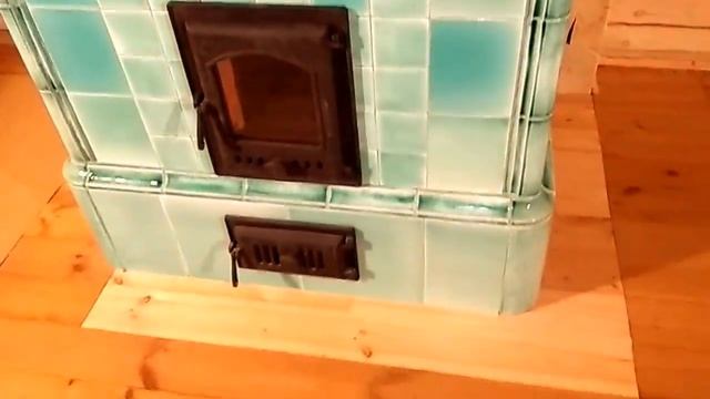 A tiled stove Art Nouveau style in a mint color