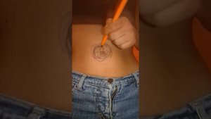 Paiting my belly button with a pen.