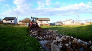 Трактор т-25 разгребает строительный мусор