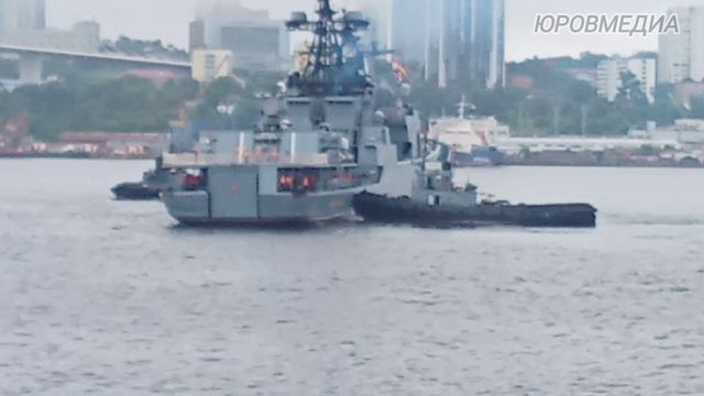 В День ВМФ буксиры швартуют военный корабль к причалу Владивосток