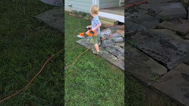 Kid using his weedwacker