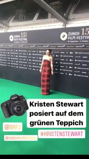 Kristen Stewart posing on the green carpet