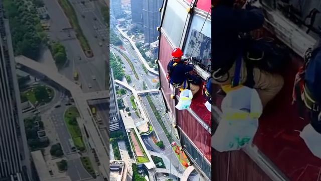 Workers cleaning high rise buildings