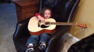 Noble plays guitar