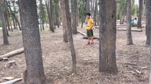 Jaden Louis paying in the woods at Yellowstone National Park