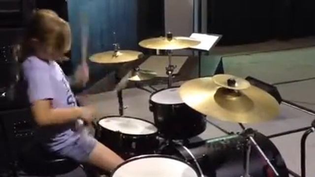 Emma learning paradiddles around the kit