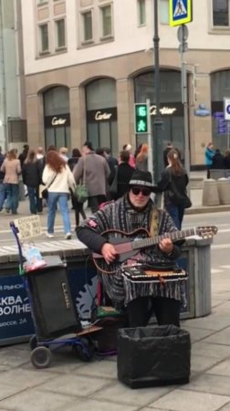 Уличный музыкант на улице Петровка в центре Москвы