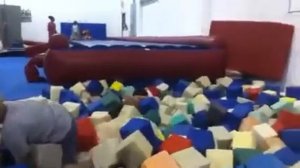 Amanda jumping into the foam pit