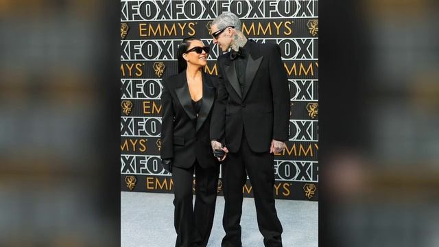 Kourtney Kardashian and Travis Barker/ match in black suits at the Emmy Awards